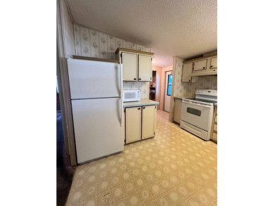Take a look at this charming and spacious partially furnished on Lake Henry Golf Club in Florida - for sale on GolfHomes.com, golf home, golf lot