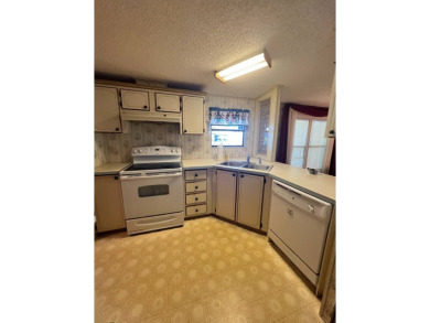 Take a look at this charming and spacious partially furnished on Lake Henry Golf Club in Florida - for sale on GolfHomes.com, golf home, golf lot