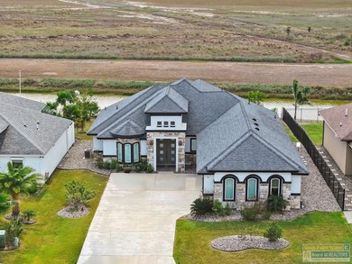 Beautiful lakefront home in the SPI Golf Community! This on South Padre Island Golf Club in Texas - for sale on GolfHomes.com, golf home, golf lot