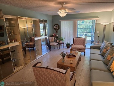 Enjoy golf course views from this beautifully maintained on Wynmoor Golf Course in Florida - for sale on GolfHomes.com, golf home, golf lot
