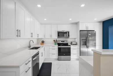 Welcome to this inviting 1st‑floor home showcasing serene on Quail Ridge Golf Course and Country Club in Florida - for sale on GolfHomes.com, golf home, golf lot