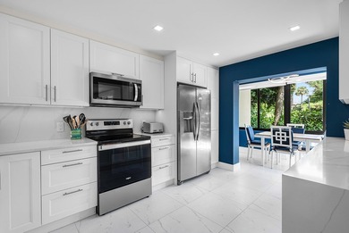 Welcome to this inviting 1st‑floor home showcasing serene on Quail Ridge Golf Course and Country Club in Florida - for sale on GolfHomes.com, golf home, golf lot