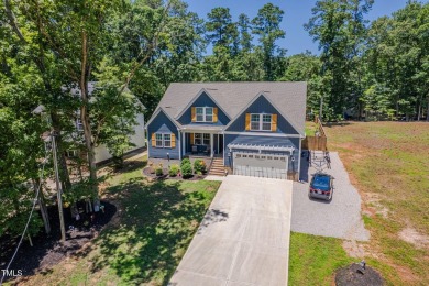 Resort-style living awaits in this beautifully crafted 2023 on River Golf and County Club at Lake Royale in North Carolina - for sale on GolfHomes.com, golf home, golf lot