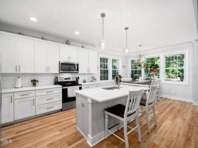 Resort-style living awaits in this beautifully crafted 2023 on River Golf and County Club at Lake Royale in North Carolina - for sale on GolfHomes.com, golf home, golf lot