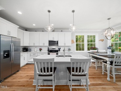 Resort-style living awaits in this beautifully crafted 2023 on River Golf and County Club at Lake Royale in North Carolina - for sale on GolfHomes.com, golf home, golf lot