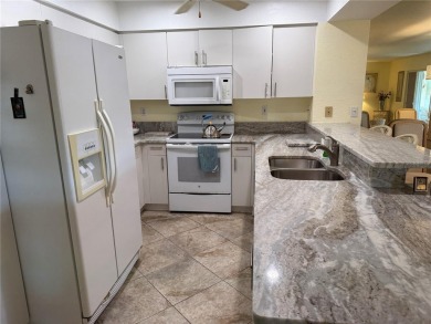 Impressive second floor light and bright END UNIT offers views on Saint Andrews South Golf Club in Florida - for sale on GolfHomes.com, golf home, golf lot