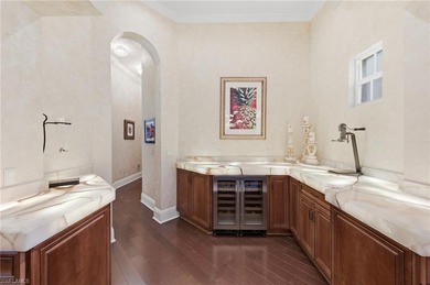 Discover refined living in this custom-built, two-story estate on Naples National Golf Club in Florida - for sale on GolfHomes.com, golf home, golf lot