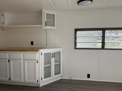 THIS FRESHLY REHABBED HOME OFFERS TINY HOUSE LIVING IN ONE OF on Triple S Golf Ranch in Florida - for sale on GolfHomes.com, golf home, golf lot