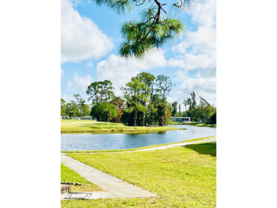 Charming 2-Bed, 2-Bath Home with Water View in Pine Lakes on Pine Lakes Country Club in Florida - for sale on GolfHomes.com, golf home, golf lot