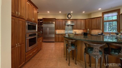 This executive home features 6750 sq. ft. Conveniently located on Marquette Golf Club in Michigan - for sale on GolfHomes.com, golf home, golf lot