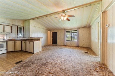 Adorable vintage Cantway doublewide manufactured home provides on The Oaks Golf Club in Florida - for sale on GolfHomes.com, golf home, golf lot