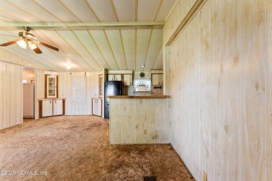 Adorable vintage Cantway doublewide manufactured home provides on The Oaks Golf Club in Florida - for sale on GolfHomes.com, golf home, golf lot