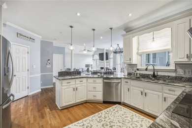 Welcome to this 5-bedroom home that sits on a corner lot and on Towne Lake Hills Golf Club in Georgia - for sale on GolfHomes.com, golf home, golf lot