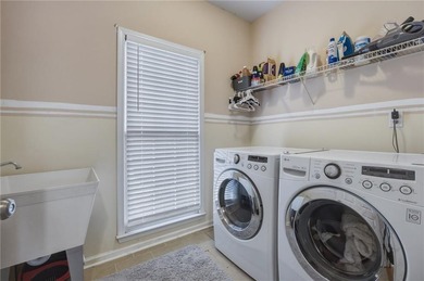 Welcome to this 5-bedroom home that sits on a corner lot and on Towne Lake Hills Golf Club in Georgia - for sale on GolfHomes.com, golf home, golf lot