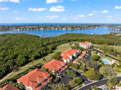 This nicely updated second-floor end-unit coach home, located in on Windstar on Naples Bay in Florida - for sale on GolfHomes.com, golf home, golf lot