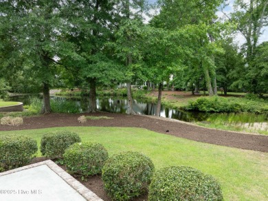 Nestled in a quiet cul-de-sac and backed by a serene pond shaded on Members Club At St. James Plantation in North Carolina - for sale on GolfHomes.com, golf home, golf lot