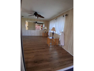This lovely 1982 mobile home comes unfurnished and is poised and on Royal Wood Golf and Country Club in Florida - for sale on GolfHomes.com, golf home, golf lot