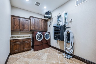 Nearly 6,000 Sq Ft of Purposeful Luxury with Dual Primary Suites on Laughlin Ranch Golf Club in Arizona - for sale on GolfHomes.com, golf home, golf lot