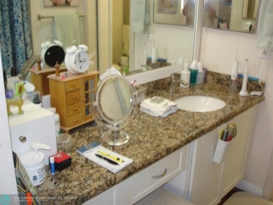 This 1st floor inside corner condo has an assigned parking spot on Sunrise Lakes Phase IV Golf Course in Florida - for sale on GolfHomes.com, golf home, golf lot