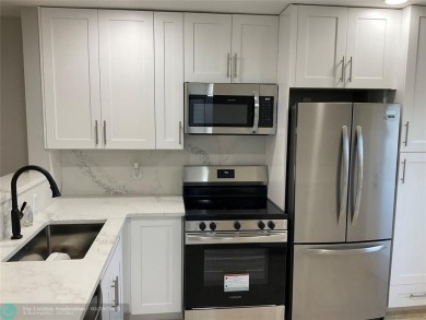 This beautifully remodeled condo in a gated community provides on Inverrary Country Club in Florida - for sale on GolfHomes.com, golf home, golf lot