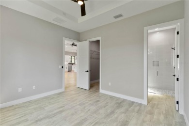 This brand-new, custom-built residence is nestled in the serene on Rotonda Golf and Country Club The Palms Course in Florida - for sale on GolfHomes.com, golf home, golf lot