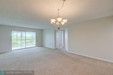 A beautiful lake view 2/2 unit on the top 4th floor located in on Flamingo Lakes Country Club in Florida - for sale on GolfHomes.com, golf home, golf lot