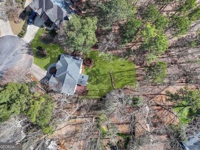 Welcome to this exceptional brick estate in the highly desirable on Towne Lake Hills Golf Club in Georgia - for sale on GolfHomes.com, golf home, golf lot