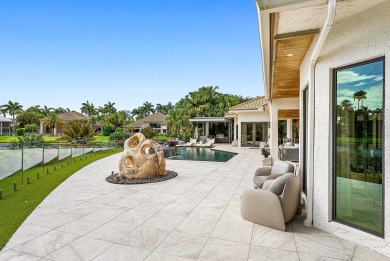 Perched on a rare, oversized lot at the end of a quiet on Boca Delray Golf and Country Club in Florida - for sale on GolfHomes.com, golf home, golf lot