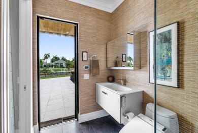 Perched on a rare, oversized lot at the end of a quiet on Boca Delray Golf and Country Club in Florida - for sale on GolfHomes.com, golf home, golf lot