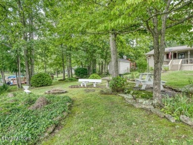 Lakefront Home with Detached Garage and Covered Boat Dock.  Step on Lake Tansi Village Country Club in Tennessee - for sale on GolfHomes.com, golf home, golf lot