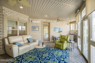 This home boasts captivating sunset views over the 3rd hole of on Cape Fear National At Brunswick Forest in North Carolina - for sale on GolfHomes.com, golf home, golf lot