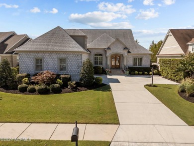 This home boasts captivating sunset views over the 3rd hole of on Cape Fear National At Brunswick Forest in North Carolina - for sale on GolfHomes.com, golf home, golf lot