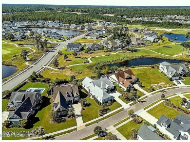 This home boasts captivating sunset views over the 3rd hole of on Cape Fear National At Brunswick Forest in North Carolina - for sale on GolfHomes.com, golf home, golf lot