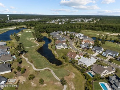 This home boasts captivating sunset views over the 3rd hole of on Cape Fear National At Brunswick Forest in North Carolina - for sale on GolfHomes.com, golf home, golf lot