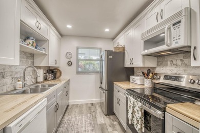 Enjoy the best of South Florida living in this beautifully on  in Florida - for sale on GolfHomes.com, golf home, golf lot