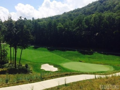 This 1 acre lot while gently sloping, overlooks the 17th green on Lake Toxaway Country Club in North Carolina - for sale on GolfHomes.com, golf home, golf lot