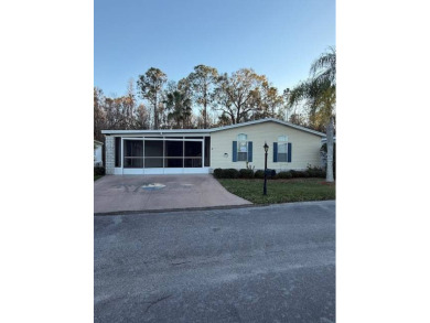 Lovely large home nestled in a wooded setting of The Hamptons on Hamptons Golf Club in Florida - for sale on GolfHomes.com, golf home, golf lot