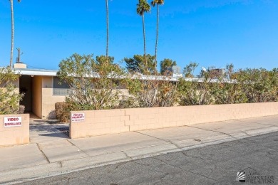 Beautifuly maintained home with picture windows to covered patio on Yuma Golf and Country Club in Arizona - for sale on GolfHomes.com, golf home, golf lot