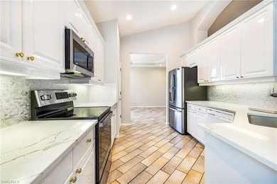 Step into a home that feels equal parts refined and on West Bay Beach and Golf Club in Florida - for sale on GolfHomes.com, golf home, golf lot