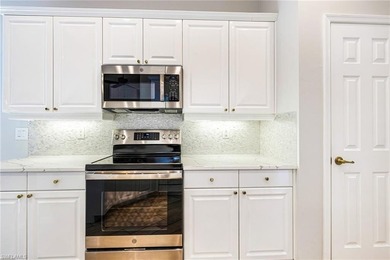 Step into a home that feels equal parts refined and on West Bay Beach and Golf Club in Florida - for sale on GolfHomes.com, golf home, golf lot