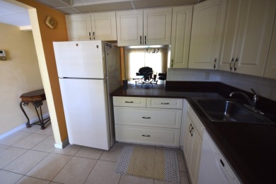Enjoy serene golf course views and resort-style amenities in on Oriole Golf and Tennis Club in Florida - for sale on GolfHomes.com, golf home, golf lot