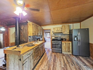 This charming Northwoods-style 1 bed, 1 bath cabin is just on Northern Bay Golf Resort and Marina in Wisconsin - for sale on GolfHomes.com, golf home, golf lot