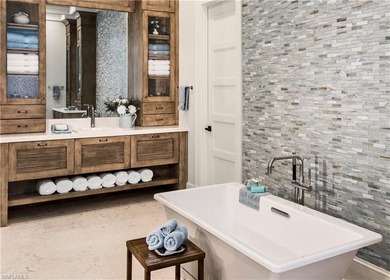 Discover refined coastal luxury in this exceptional estate on Club at Pelican Bay Golf Course in Florida - for sale on GolfHomes.com, golf home, golf lot