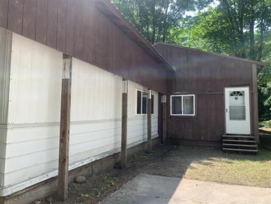 Generations have embraced the up-north lifestyle in this on Lakes of the North Deer Run Golf Course in Michigan - for sale on GolfHomes.com, golf home, golf lot