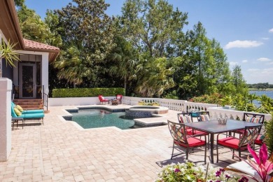 Experience refined lakefront living in this exceptional estate on Isleworth Golf and Country Club in Florida - for sale on GolfHomes.com, golf home, golf lot