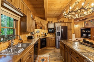 This beautiful, fully furnished, 3-bedroom, 2.5-bath wood cabin on Sapphire National Golf Club in North Carolina - for sale on GolfHomes.com, golf home, golf lot