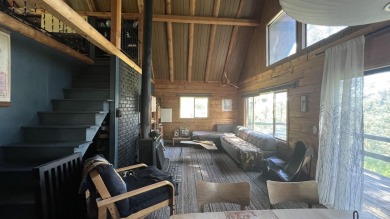 A cozy little log cabin. Two bedrooms, one is in the large open on Terrace Lakes Golf Resort in Idaho - for sale on GolfHomes.com, golf home, golf lot