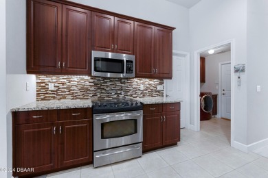 Gorgeous pool home nestled on a quiet street in the highly on Plantation Bay Golf and Country Club in Florida - for sale on GolfHomes.com, golf home, golf lot
