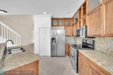 Discover this beautiful 2-story residence at the gated community on Palm-Aire Country Club and Resort - The Oaks in Florida - for sale on GolfHomes.com, golf home, golf lot