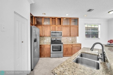 Discover this beautiful 2-story residence at the gated community on Palm-Aire Country Club and Resort - The Oaks in Florida - for sale on GolfHomes.com, golf home, golf lot